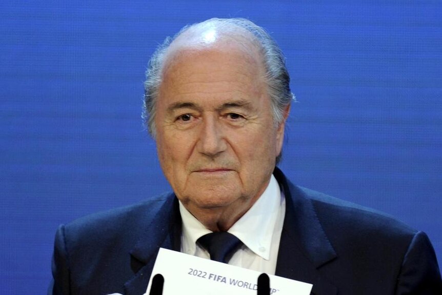 FIFA president Sepp Blatter holds up Qatar's name after announcing the 2022 World Cup hosts.