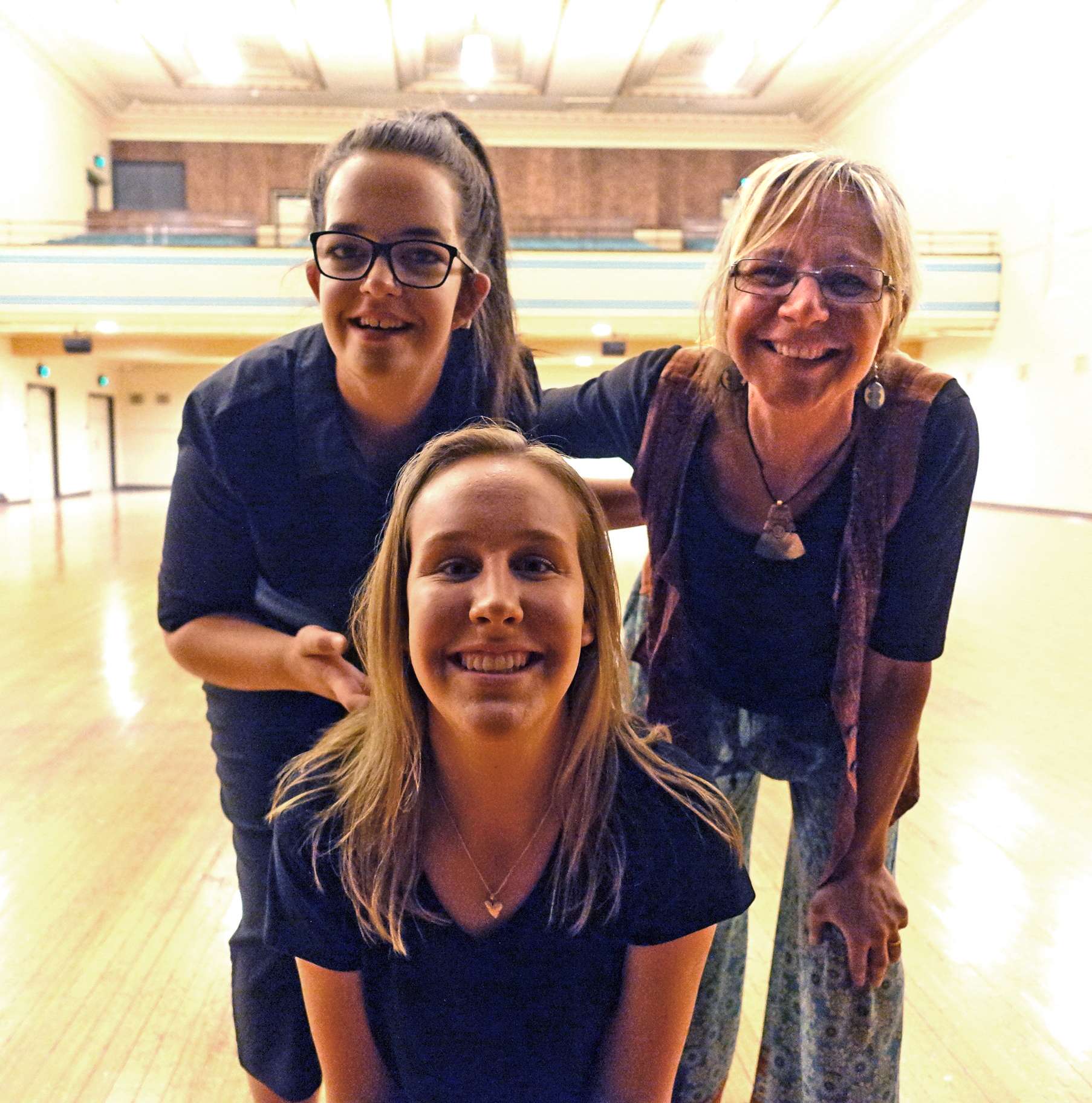 members of the choir smile at camera
