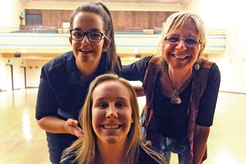 members of the choir smile at camera