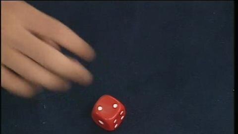 Hand near dice, dice shows two dots