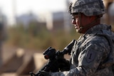 An American soldier stands guard