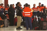 Mine workers wait at Perth Airport