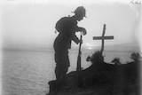 A British soldier visits his comrade's grave on the cliffs on the tip of Gallipoli Peninsula, 1915.