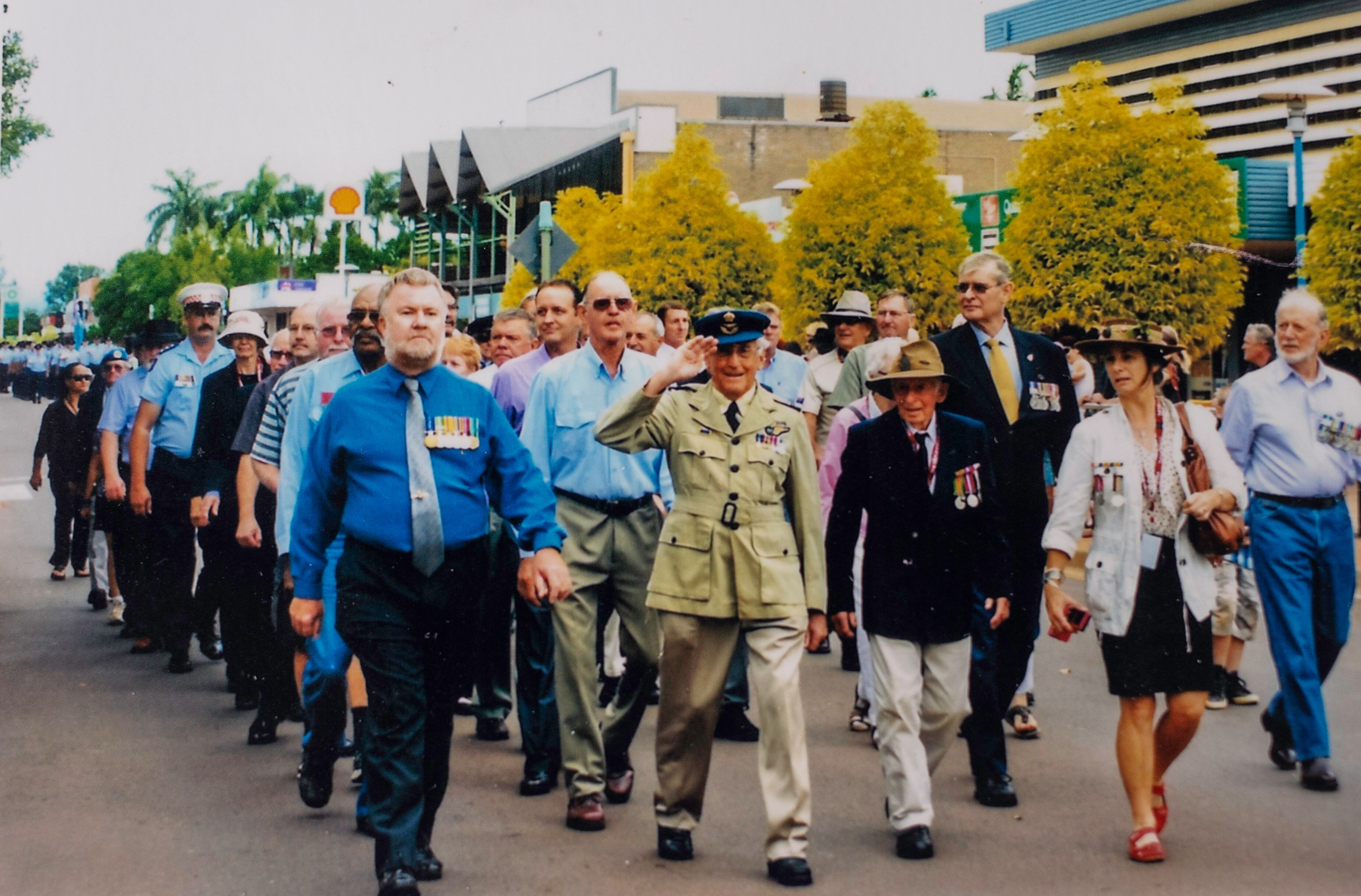 a veteran leading an anzac march