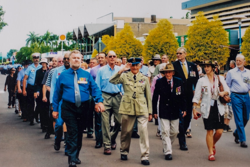 a veteran leading an anzac march