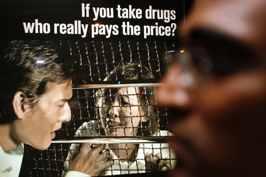 A poster in Singapore reading 'if you take drugs, who really pays the price?'