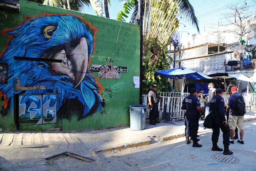 A wide shot of police guarding the entrance of the Blue Parrot nightclub.