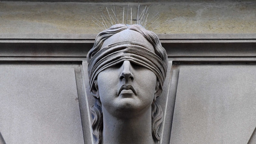 A close photo of a justice statue.
