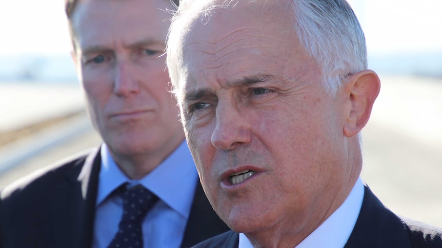 A head shot of Malcolm Turnbull with Christian Porter in the background over his right shoulder.