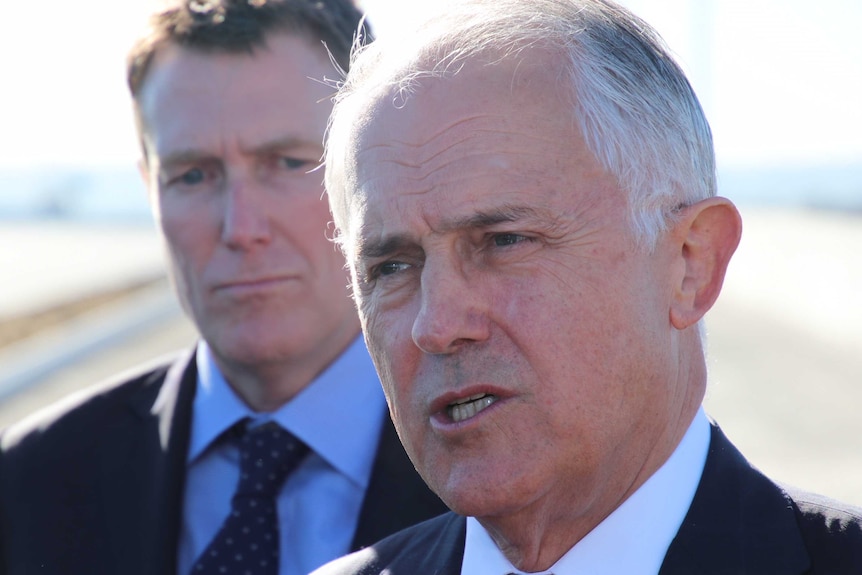 A head shot of Malcolm Turnbull with Christian Porter in the background over his right shoulder.
