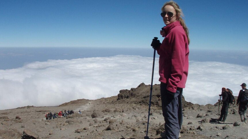Alyssa Azar stands above the clouds on Mt Kilimanjaro