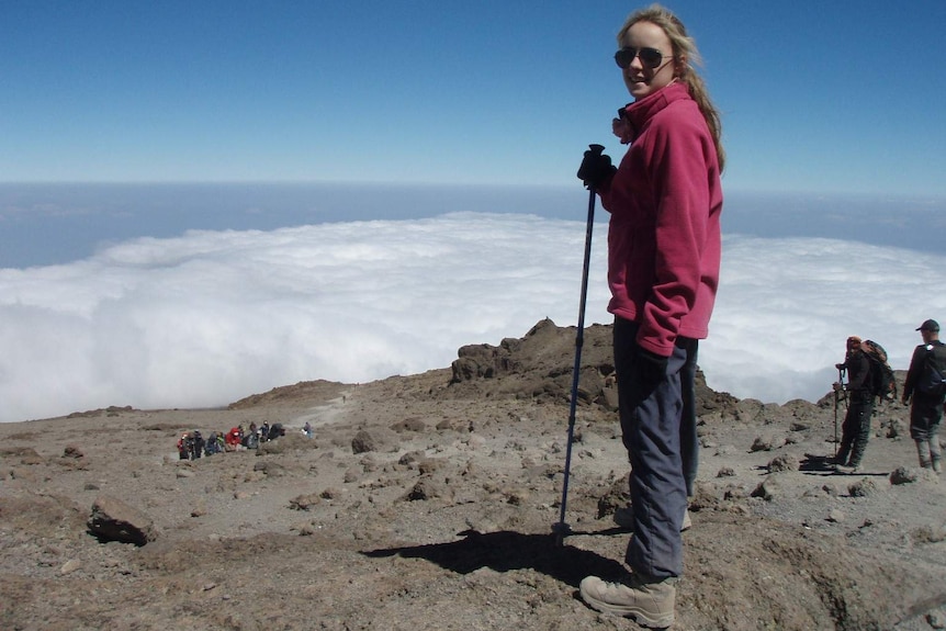 Alyssa Azar stands above the clouds on Mt Kilimanjaro