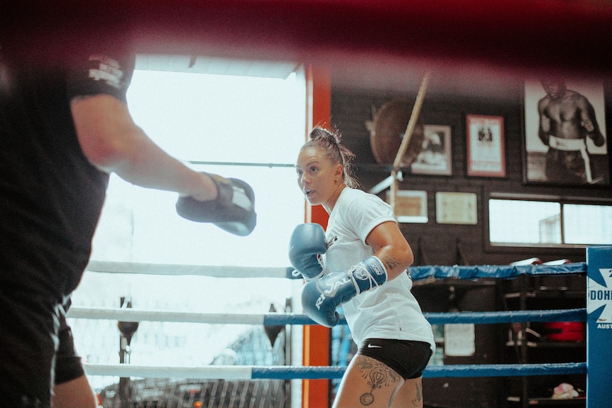 A female boxer squares up to her opponent