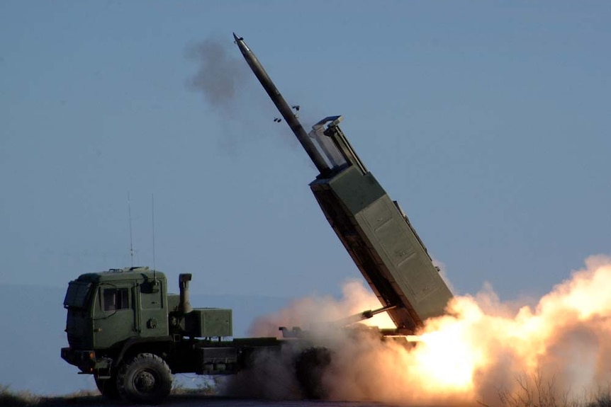 A missile launches from the back of a truck. 