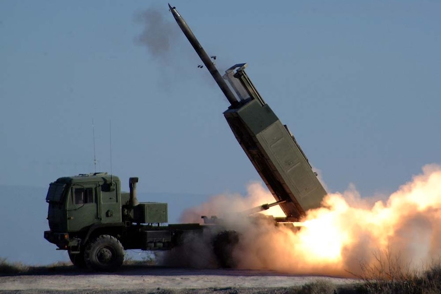 A missile launches from the back of a truck. 