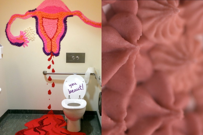 A large colourful image of a menstruating uterus bleeding onto the floor on the walls of a toilet cubicle.