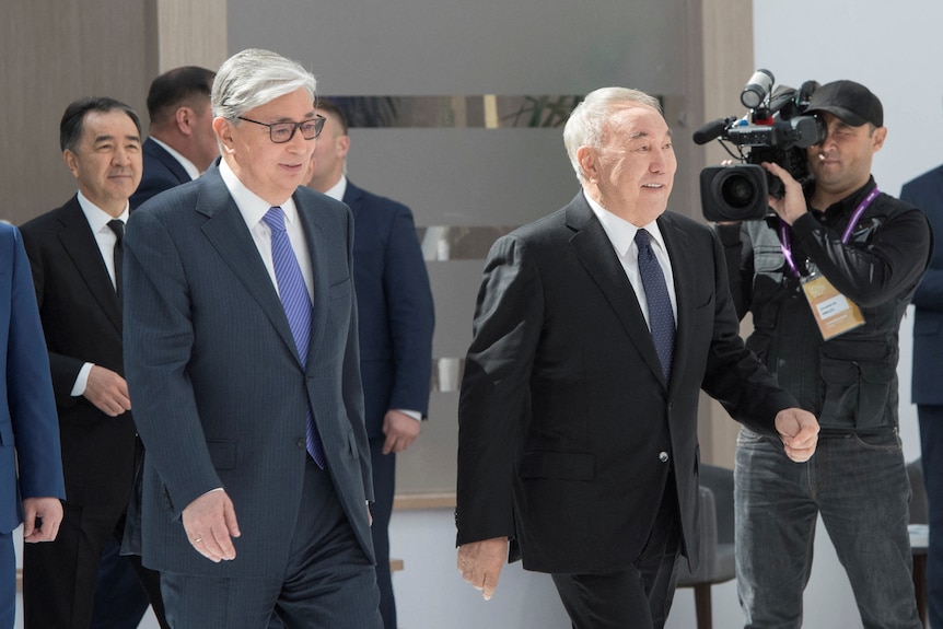 Kazakhstan's current president and former president walk side by side