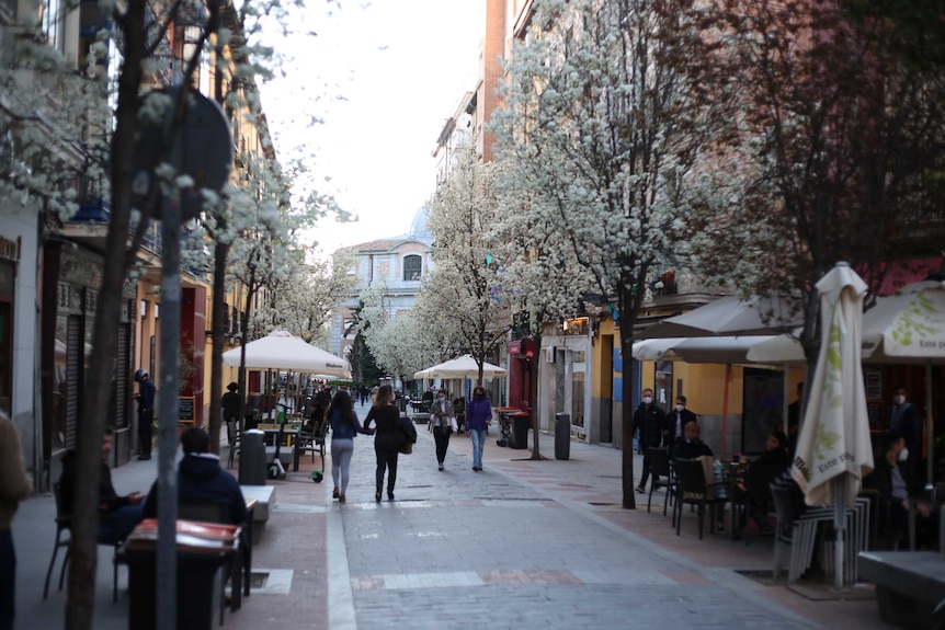 Women walk down a street.