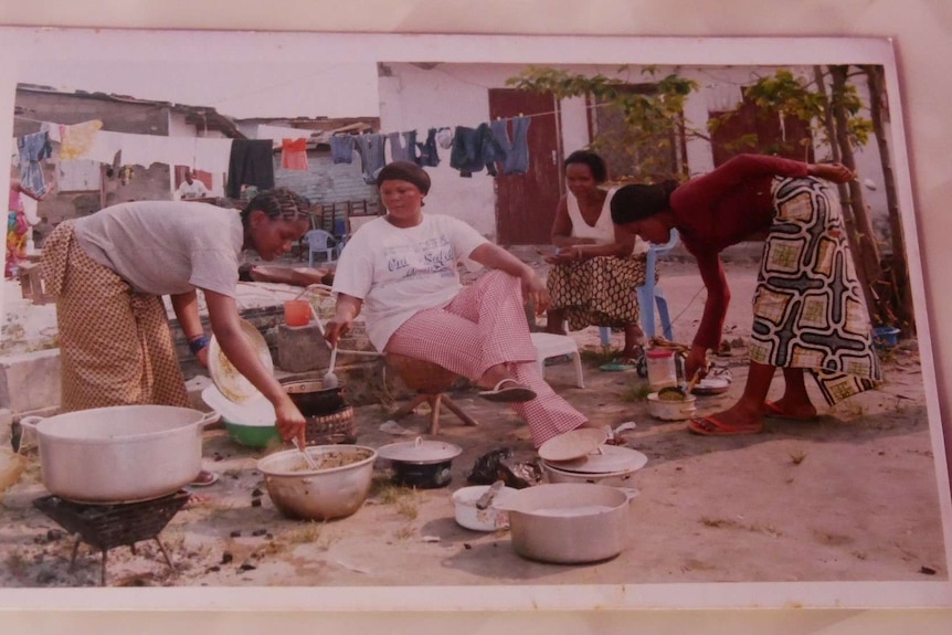 Photograph of African women cooking on the street.