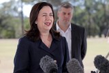 Premier Annastacia Palaszczuk speaking to the media, with Police Minister Mark Ryan in the background