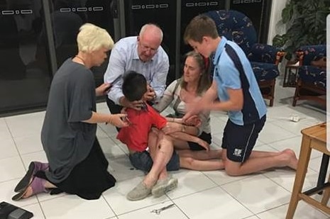Jordie, who has autism, getting a haircut, with family helping him stay calm