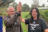 a man and woman touch hands in a high five