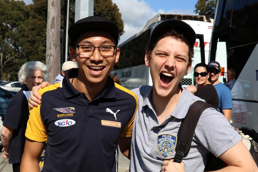 West Coast Eagles fans Daniel D'Rozario (l) and Declan McCarthy get on the bus in Perth to go to Melbourne for the AFL grand final