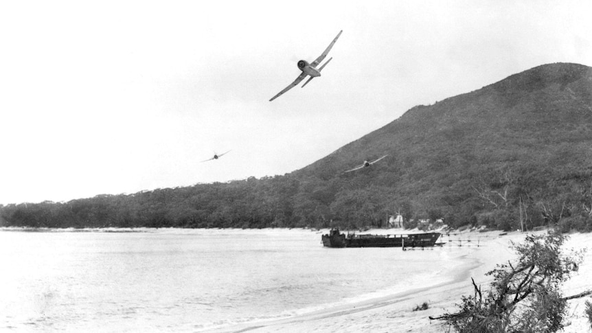 A plane flies over Mt Tomaree during WWII.