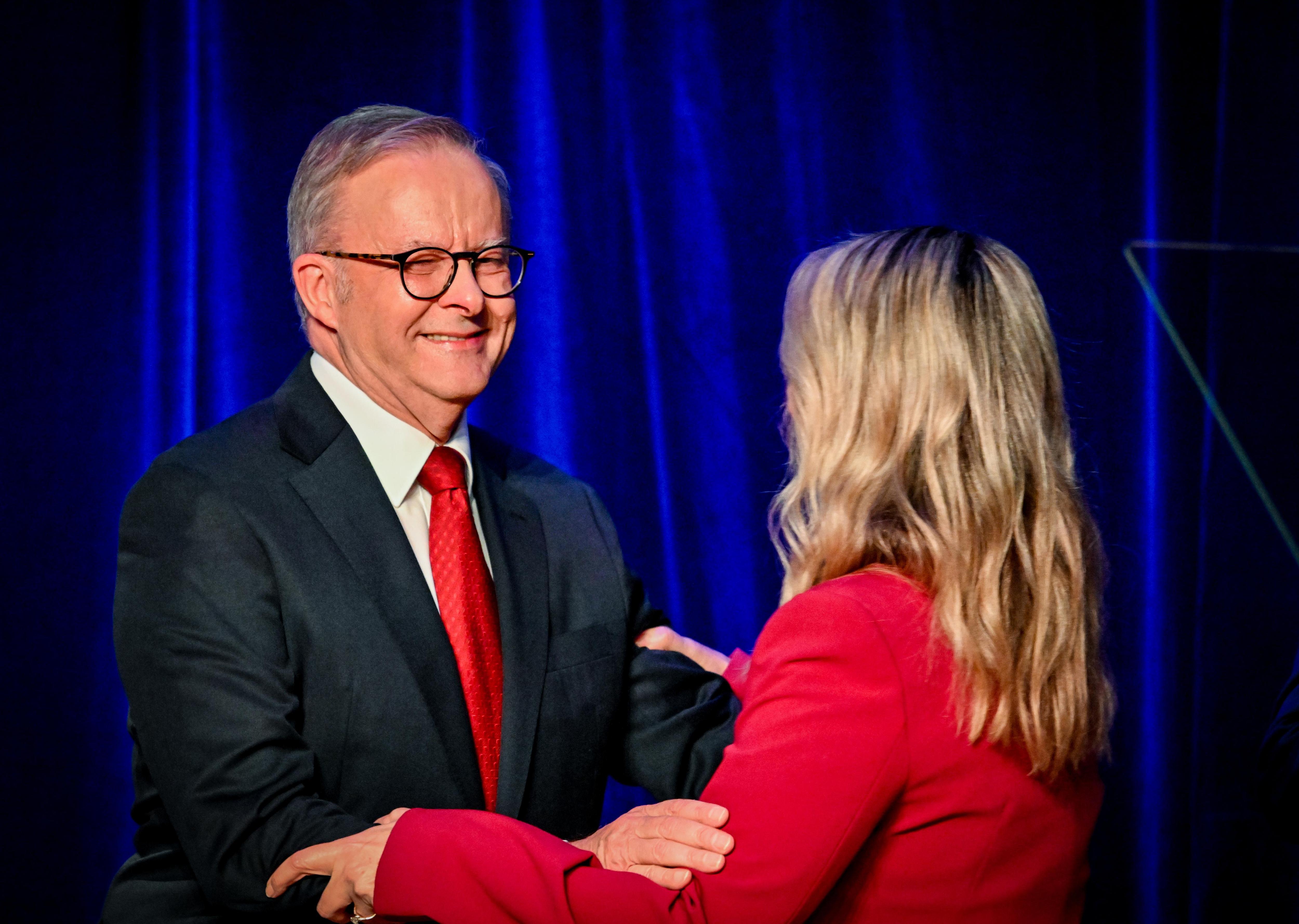 Albanese looks happily teary as he embraces his fiancee