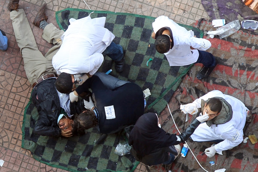 Egyptian doctors treat protesters suffering from tear gas at field hospital in Tahrir Square.