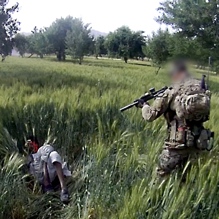 SAS soldier aims a gun at Dad Mohammad