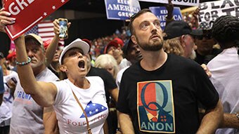 Man wearing QAnon t-shirt at rally.