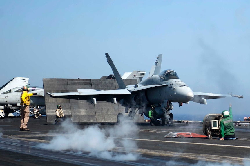 A FA18 Hornet prepares to take off from the USS Dwight D Eisenhower