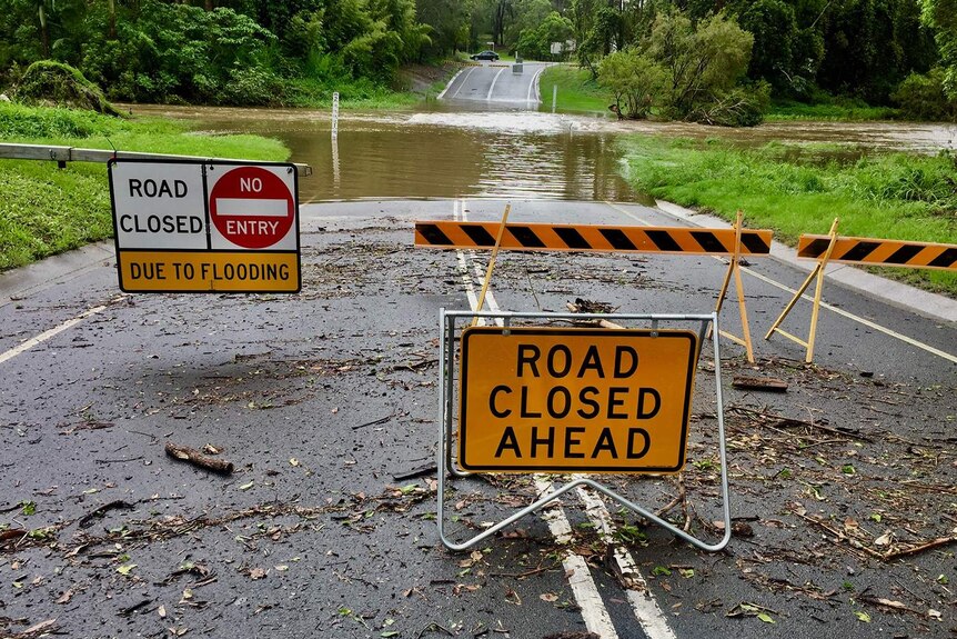 Road closed signs at flooded Hardys Road at Bonogin.
