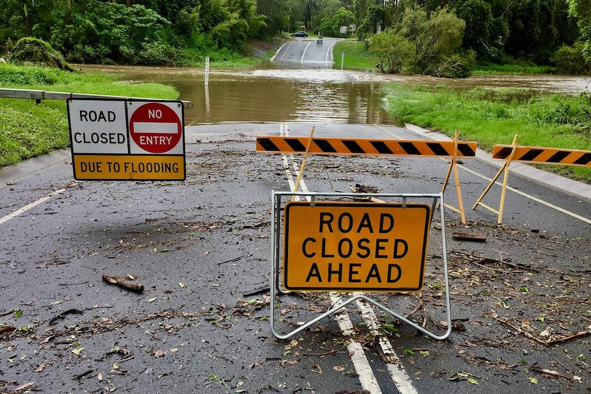 Road closed signs at flooded Hardys Road at Bonogin.
