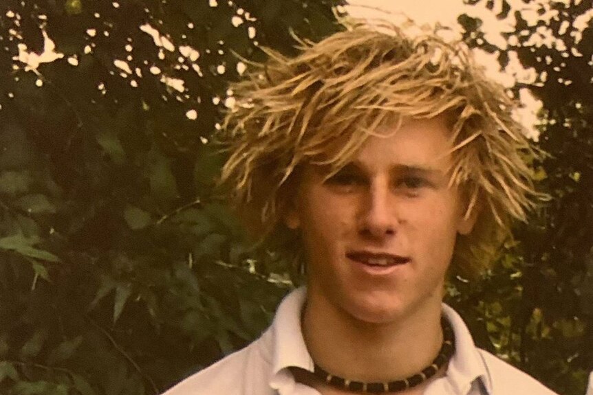 A teenage Jamin Heppell with blond dreadlocks.