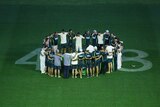 The Australian team come out after their win and huddle over the number 408 which was dedicated to the late Phillip Hughes during day five of the First Test match between Australia and India at Adelaide Oval