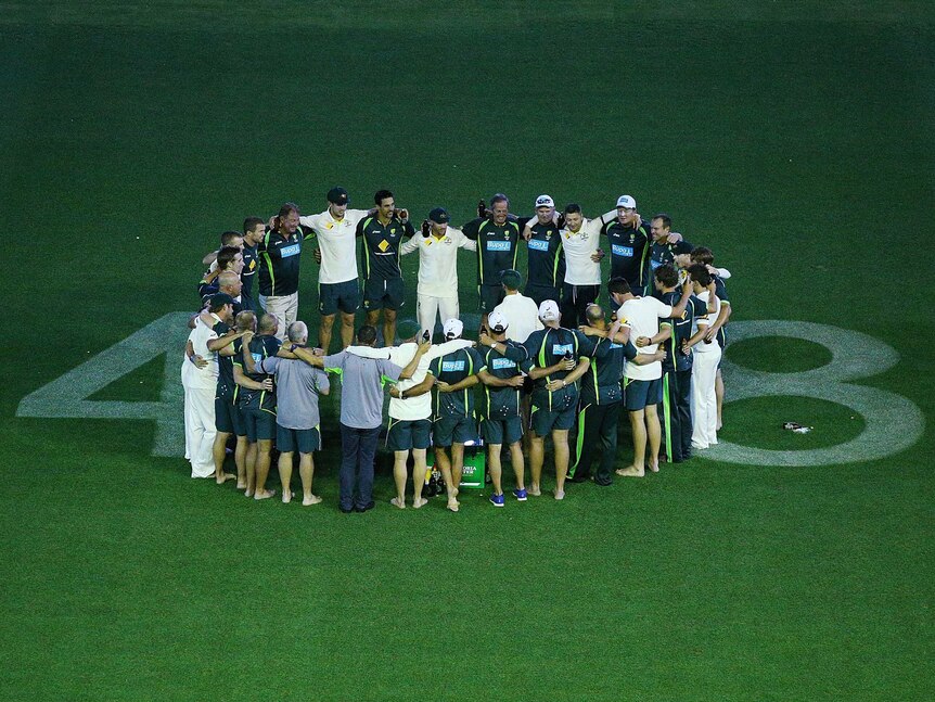The Australian team come out after their win and huddle over the number 408 which was dedicated to the late Phillip Hughes during day five of the First Test match between Australia and India at Adelaide Oval
