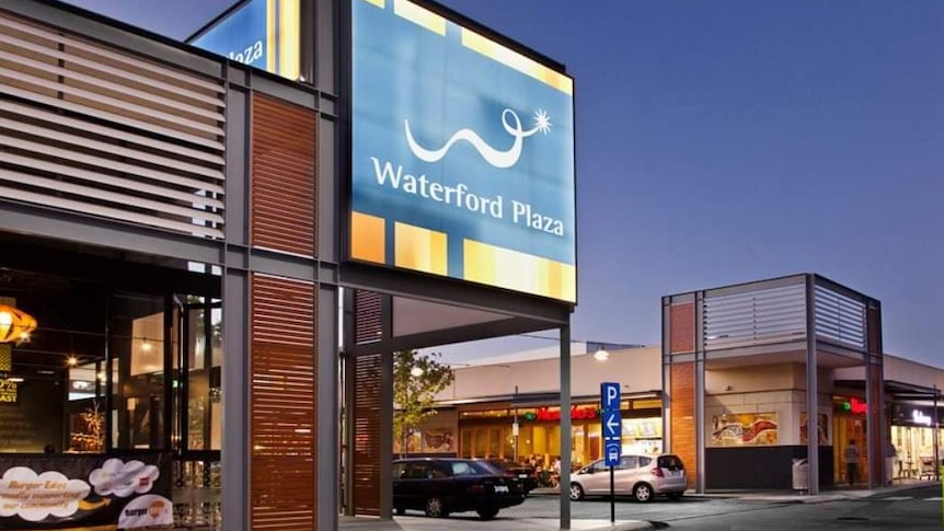 A shopping centre with the sign Waterford Plaza