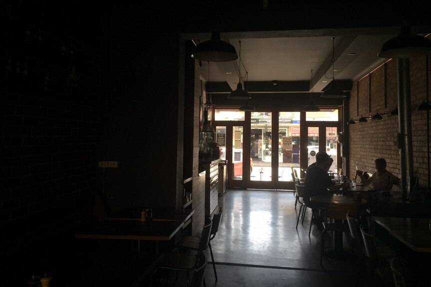 A darkened cafe in Elwood after the power was cut.