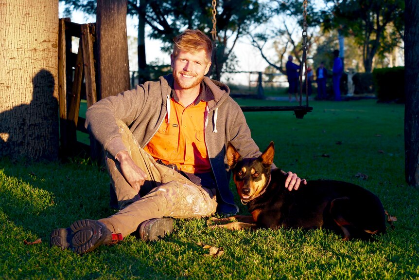 Joel Fergie in a park with his dog