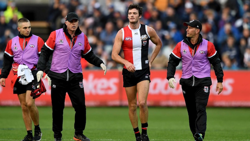 Dylan Roberton of the Saints is taken off ground after fainting against Geelong at Kardinia Park.