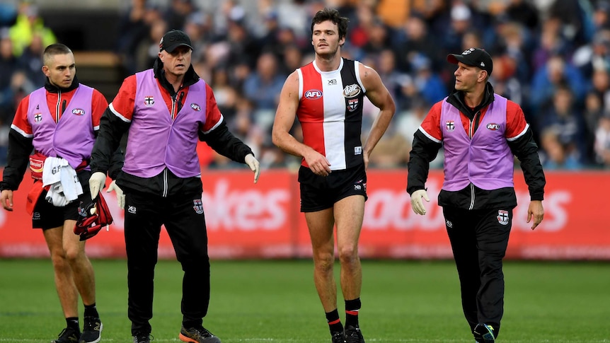 St Kilda's Dylan Roberton comes off the field after collapsing against Geelong