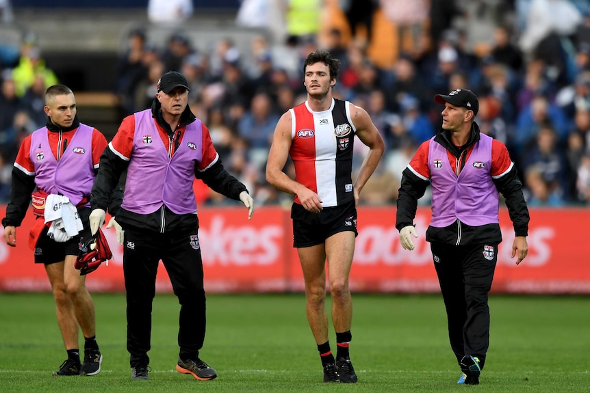 St Kilda's Dylan Roberton comes off the field after collapsing against Geelong