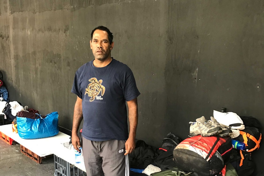 Peter Jerrard stands in front of his possessions.