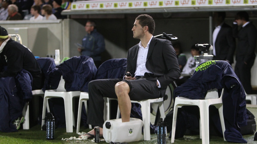 Injury woes ... Joel Thompson sits with his ankle on ice on the empty Raiders reserve bench
