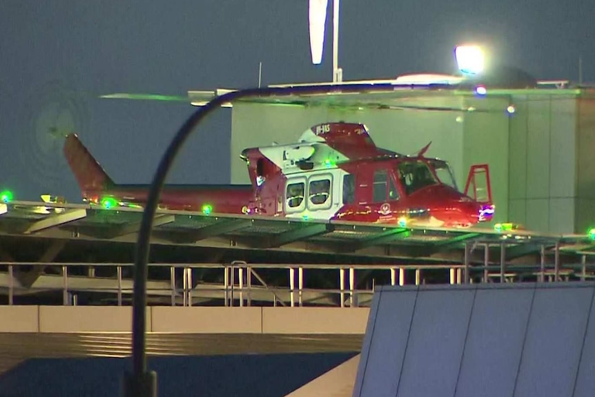 A helicopter hands on a helipad