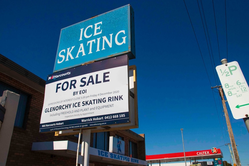 A for sale sign outside an ice skating rink.