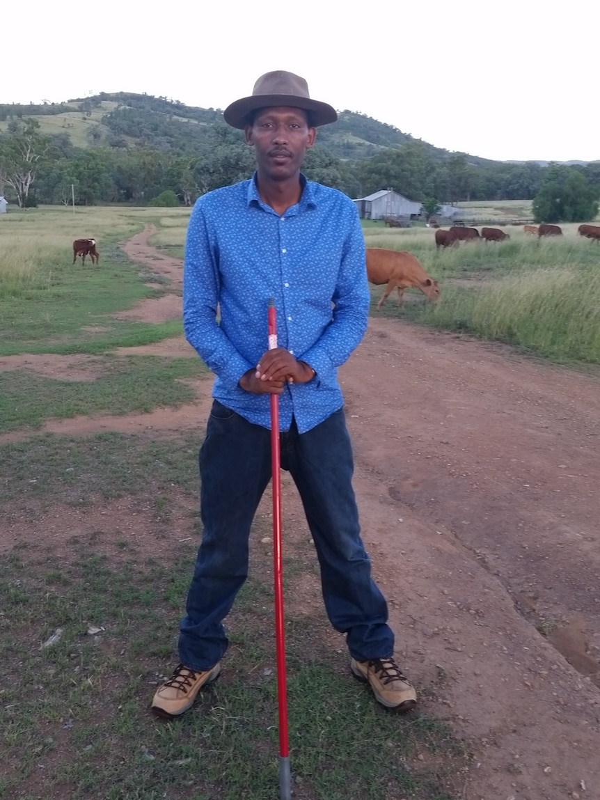 Jerome Rugaruza stands in a paddock.