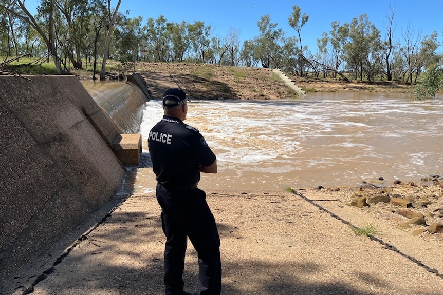 A police officer at the scene of the Loyd Jones Weir in Barcaldine.